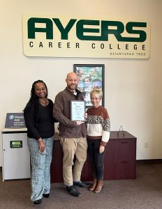 Billy Hanisee, Nichole Walker, and Karen Squyres holding USA Today plaque